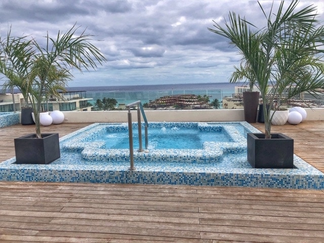 Soak in a hot tub with a view of the ocean at Reef 28 in Playa del Carmen Mexico.